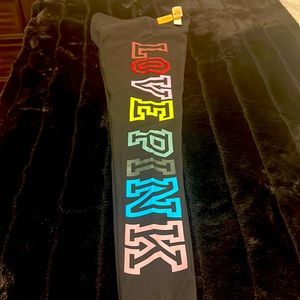 Black pink tights with multi color print on left leg brand new never worn